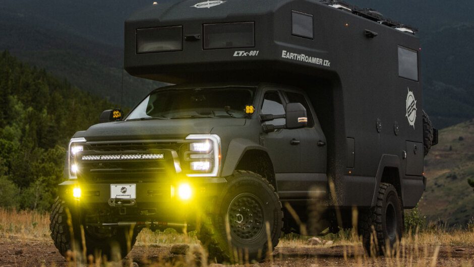 EarthRoamer LTx expedition truck on a Ford F550 Chassis with Baja Designs LED off-road lights in a mountain setting.